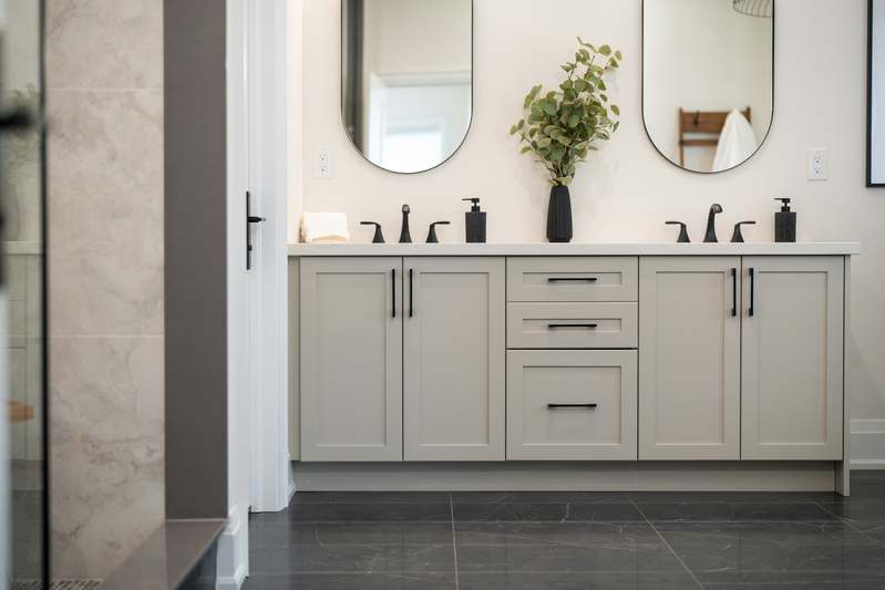 Modern bathroom with an illuminated smart mirror showing weather and calendar